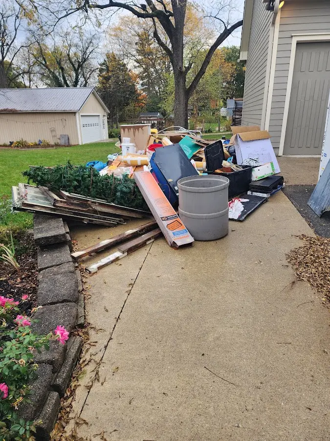 Dumpster being loaded with debris for Estate Cleanout Dumpster Rental in Avon